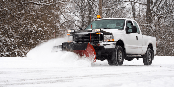 Snow plow plowing snow on a street
